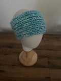Handmade knitted angora blend ear warmer in a variegated pastel rainbow colour