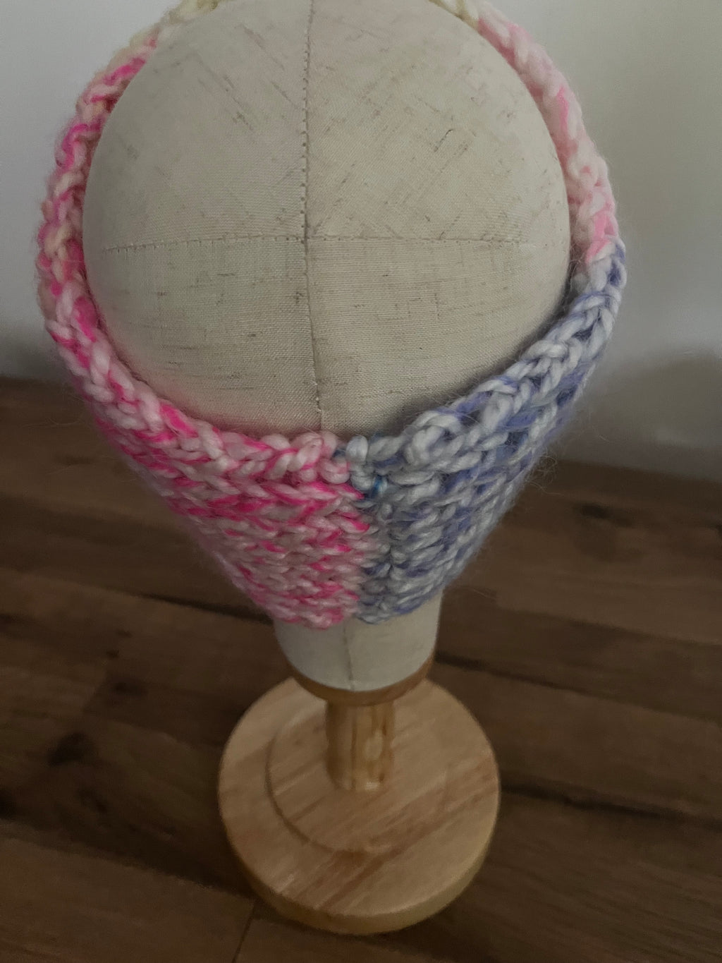Handmade knitted angora blend ear warmer in a variegated pastel rainbow colour