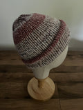 Hand made knitted beanie in a red neutral variegated colour