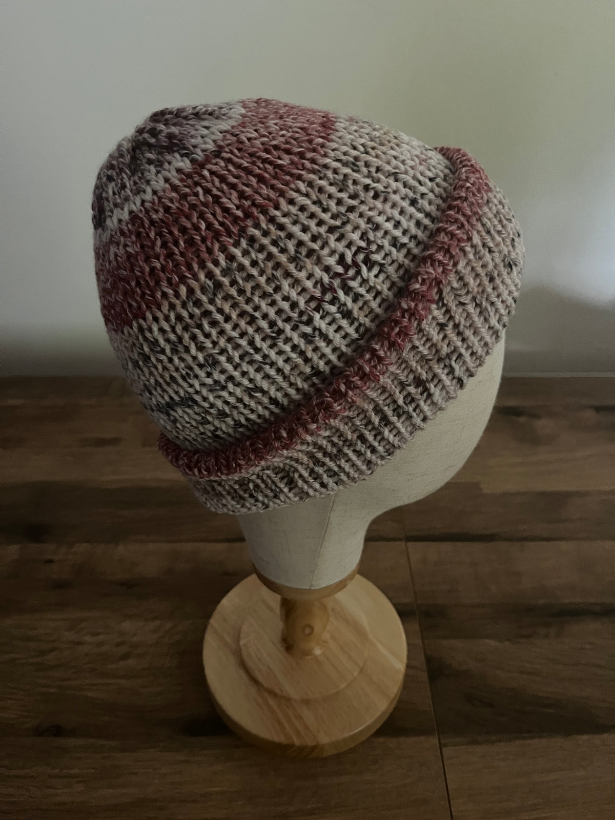 Hand made knitted beanie in a red neutral variegated colour