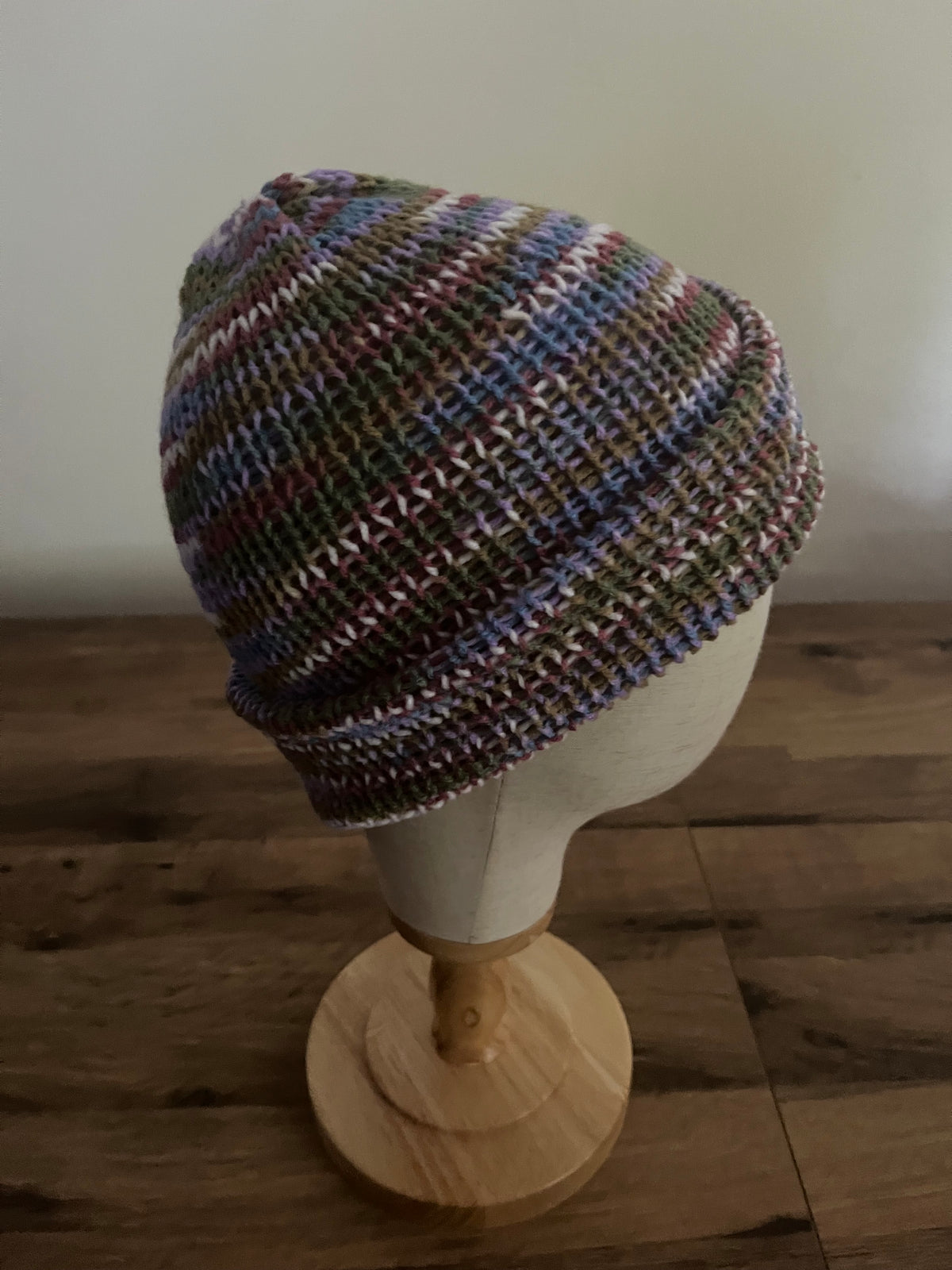 Hand made knitted beanie hat in a variegated heather meadow colour
